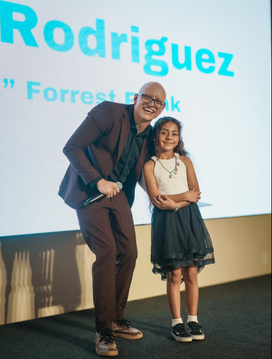 Samuel Picou on stage with student